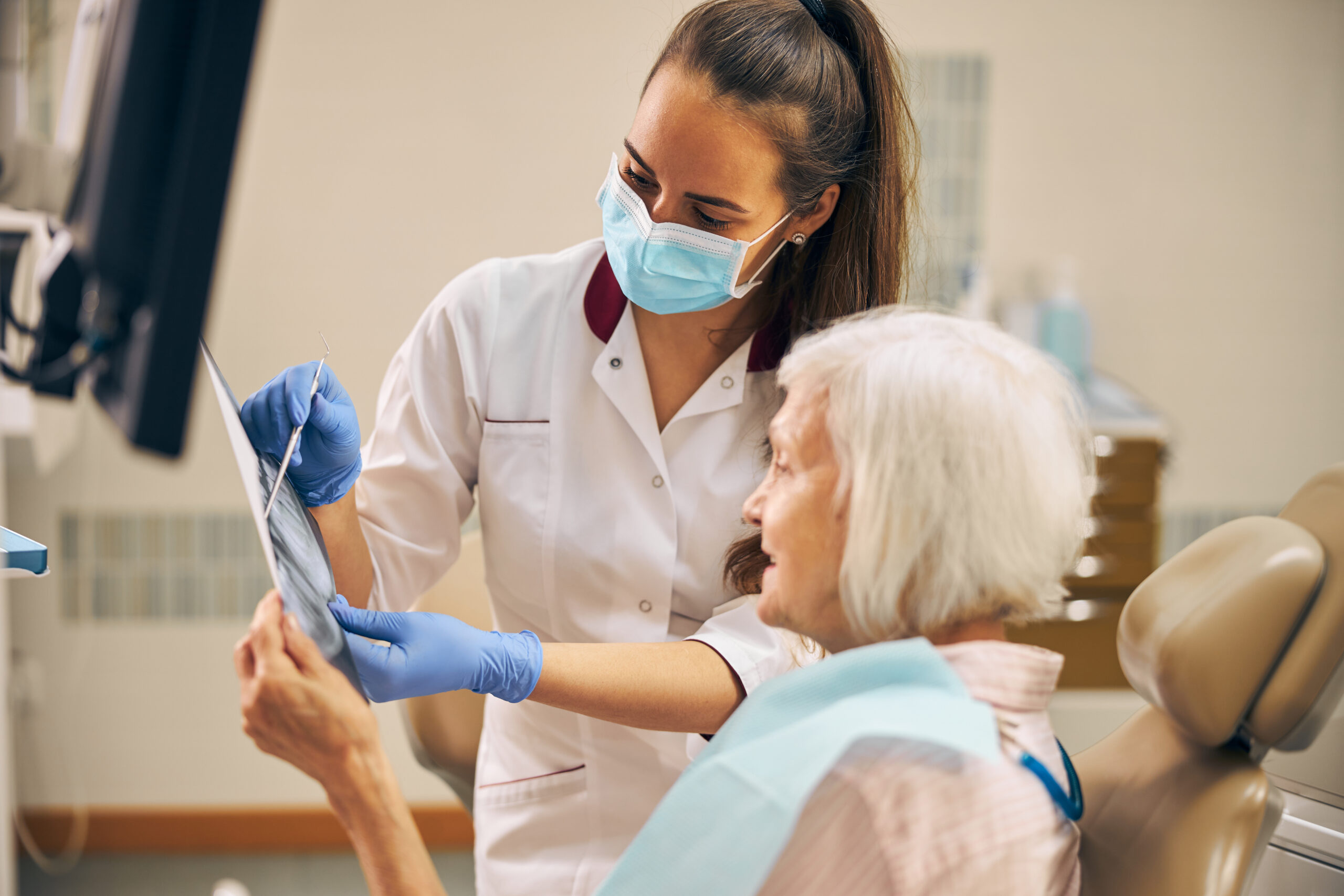 Dentist reviewing jaw and bite alignment with patient at Eccella Smiles