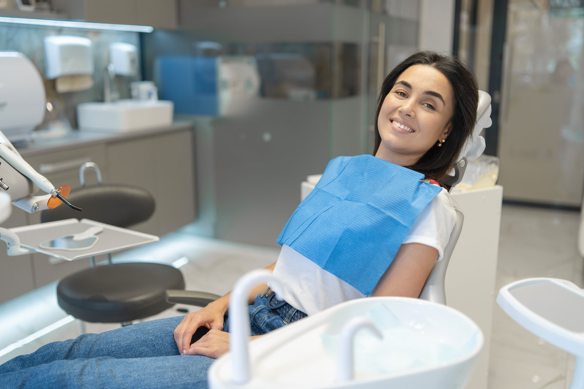 Relaxed patient smiling in dental chair during oral sedation appointment